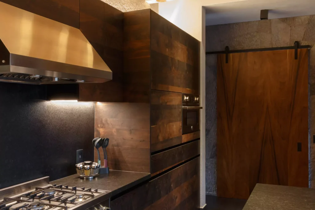 Industrial-style wooden kitchen with granite central island designed by Vitelier in Avándaro, State of Mexico