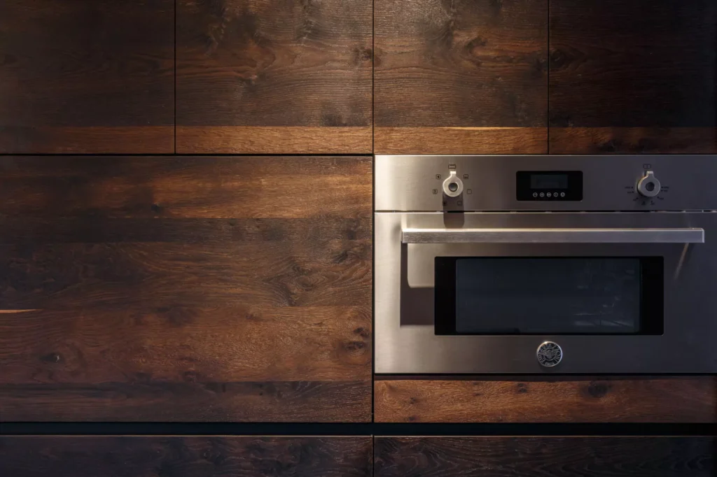 Industrial-style wooden kitchen with granite central island designed by Vitelier in Avándaro, State of Mexico