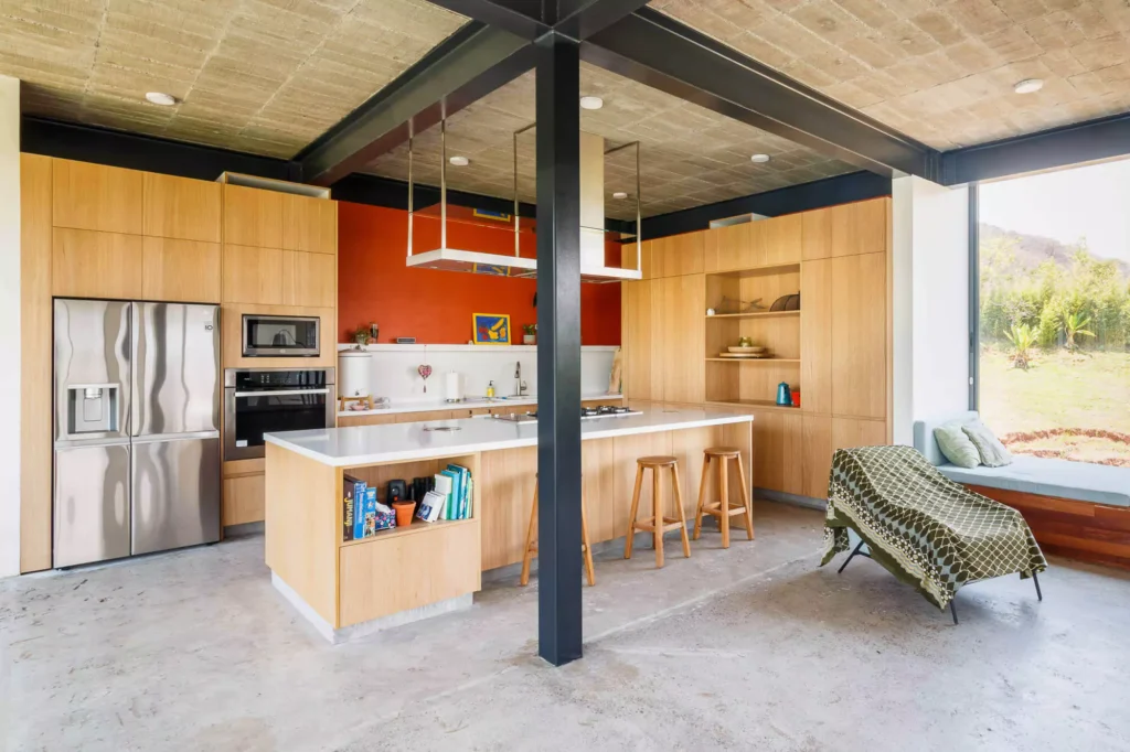 Wooden kitchen with island and stainless steel range hood, designed by Vitelier at Casa Tortuga in Valle de Bravo.