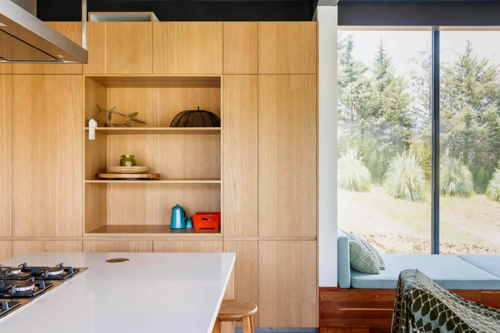 Wooden kitchen with island and stainless steel range hood, designed by Vitelier at Casa Tortuga in Valle de Bravo.