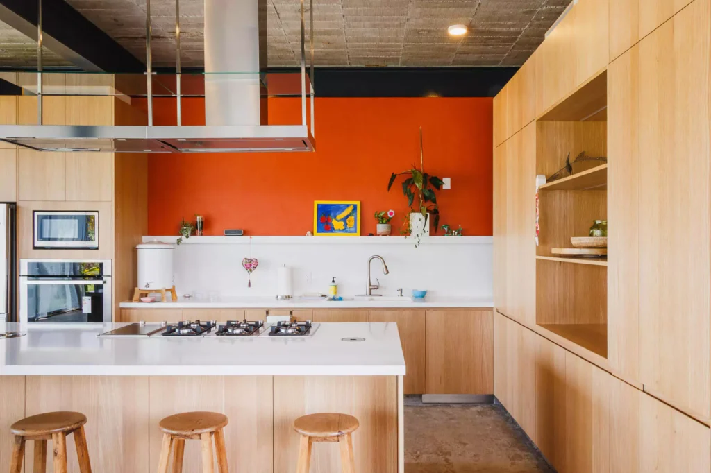 Wooden kitchen with island and stainless steel range hood, designed by Vitelier at Casa Tortuga in Valle de Bravo.