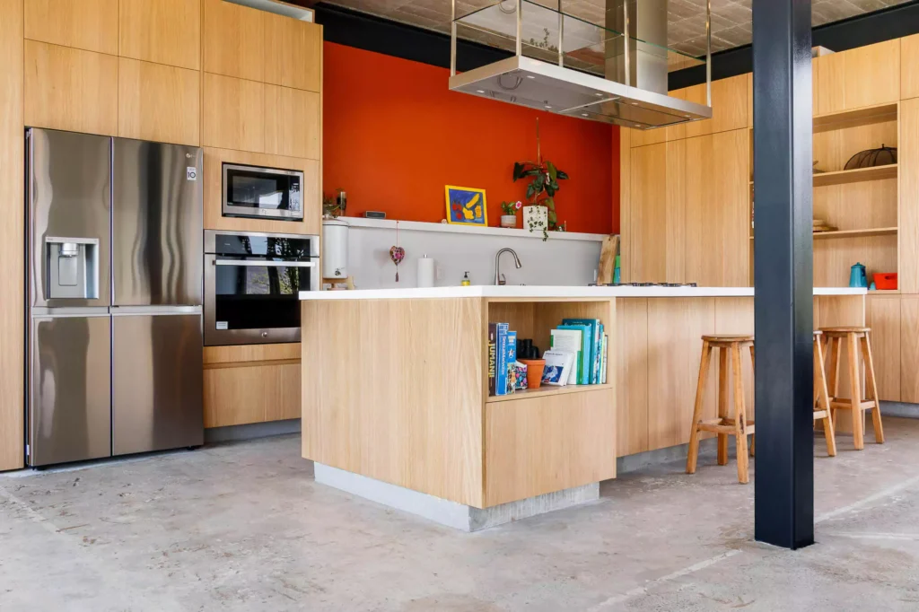 Wooden kitchen with island and stainless steel range hood, designed by Vitelier at Casa Tortuga in Valle de Bravo.