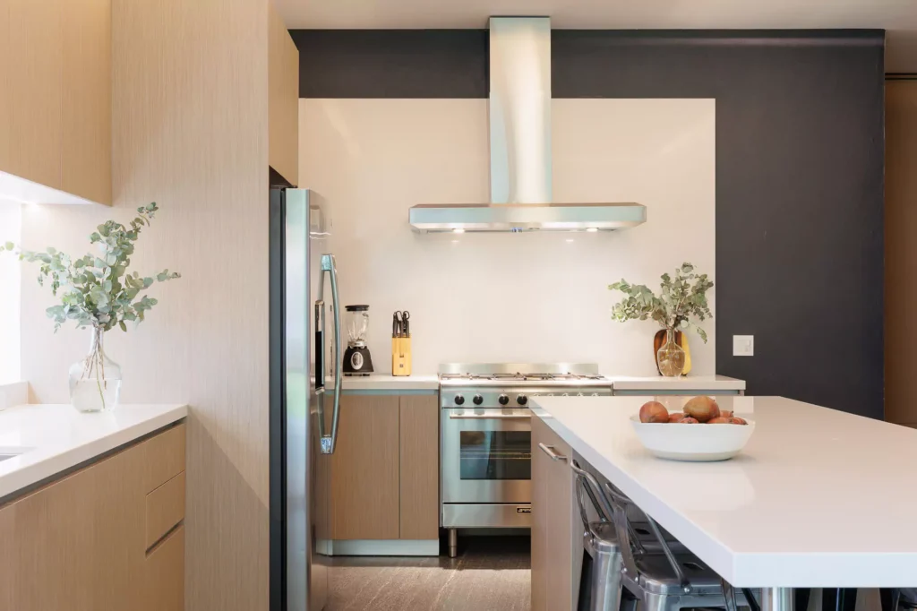 Modern kitchen with wood veneer and central island, designed by Vitelier at Granados, Colonia Bosques de las Lomas, Mexico City.