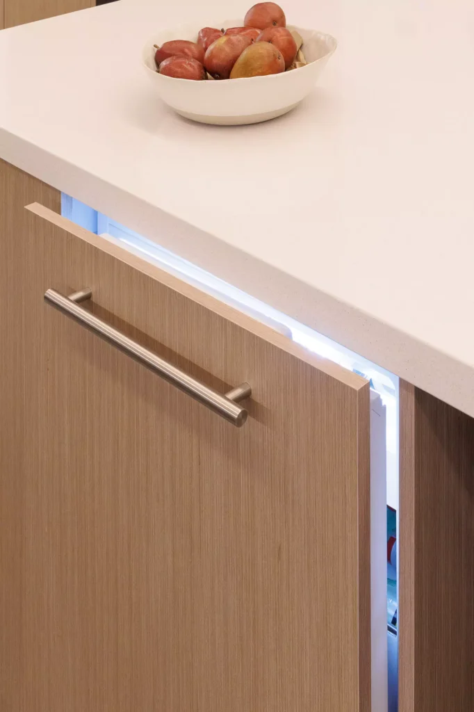 Modern kitchen with wood veneer and central island, designed by Vitelier at Granados, Colonia Bosques de las Lomas, Mexico City.