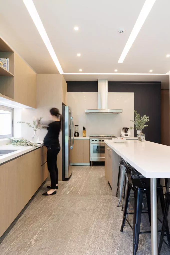 Modern kitchen with wood veneer and central island, designed by Vitelier at Granados, Colonia Bosques de las Lomas, Mexico City.