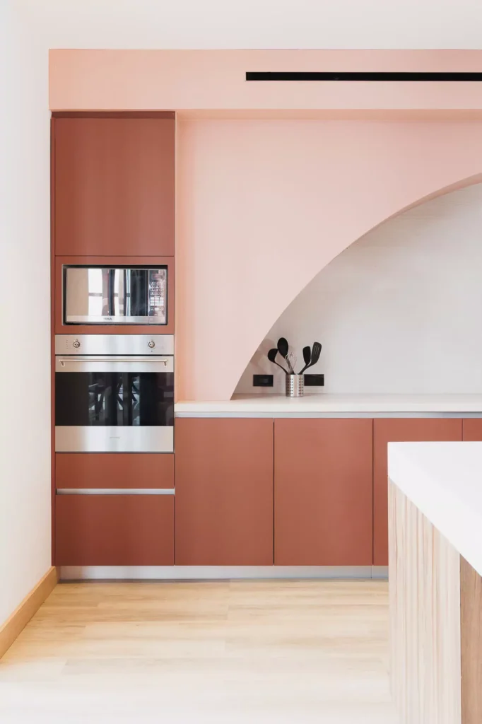 Custom terracotta kitchen with arch and central island, designed by Vitelier at Edificio Josefa in Colonia Juárez, Mexico City