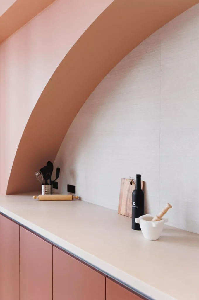 Custom terracotta kitchen with arch and central island, designed by Vitelier at Edificio Josefa in Colonia Juárez, Mexico City
