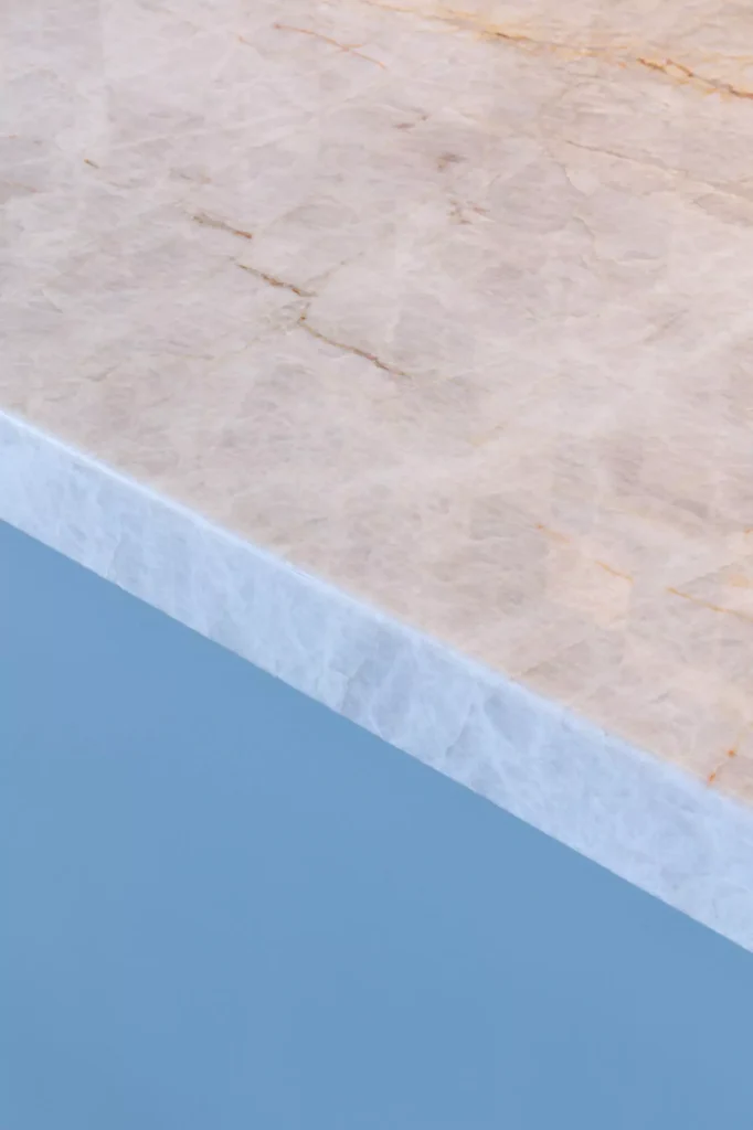 Cosentino Sensa natural stone countertop with blue cabinet in kitchen designed by Vitelier at Edificio Amalia in Colonia Nápoles, Mexico City.