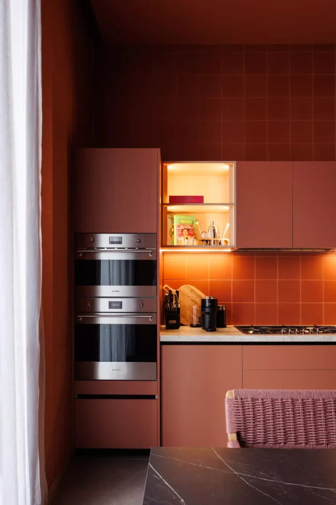Custom red kitchen designed by Vitelier at Edificio Amalia in Colonia Nápoles, Mexico City.