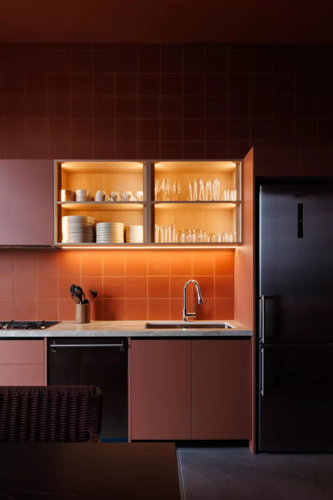 Custom red kitchen designed by Vitelier at Edificio Amalia in Colonia Nápoles, Mexico City.