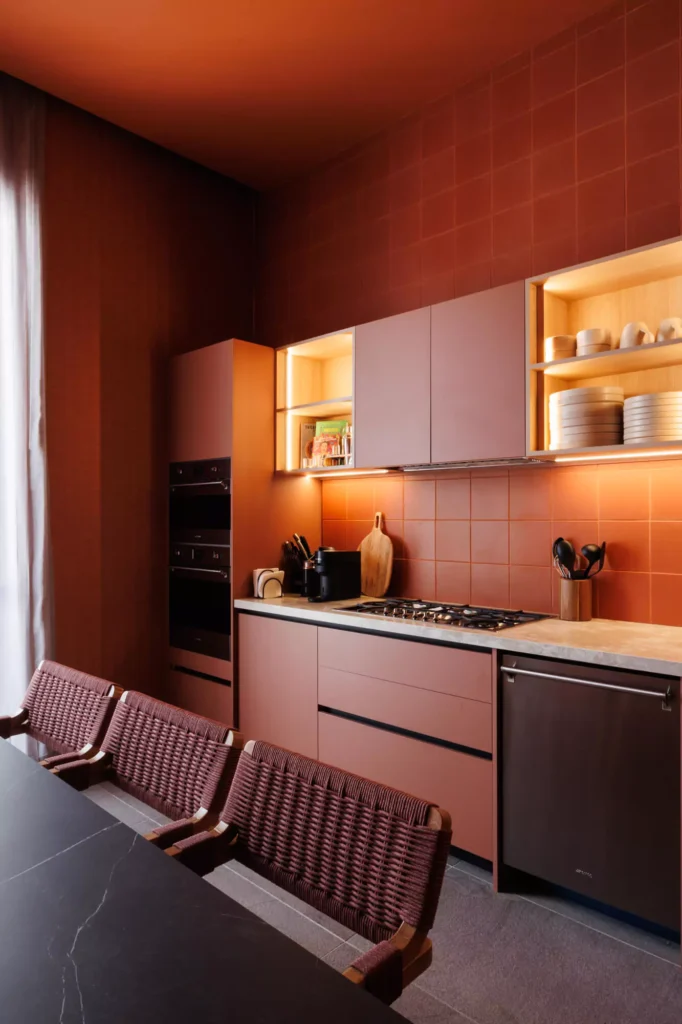 Custom red kitchen designed by Vitelier at Edificio Amalia in Colonia Nápoles, Mexico City.