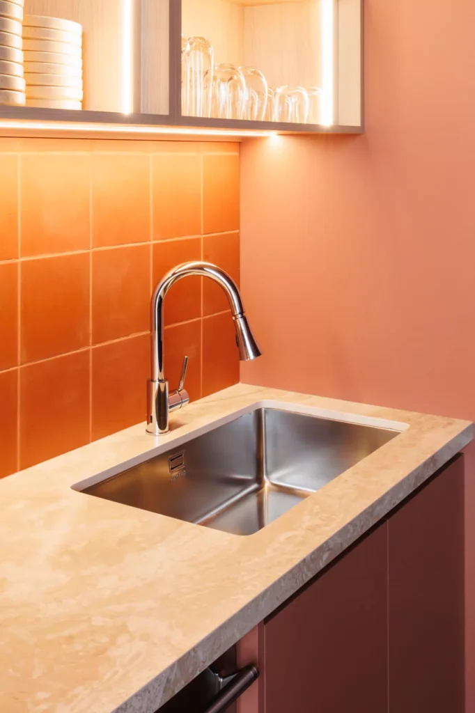 Custom red kitchen designed by Vitelier at Edificio Amalia in Colonia Nápoles, Mexico City.