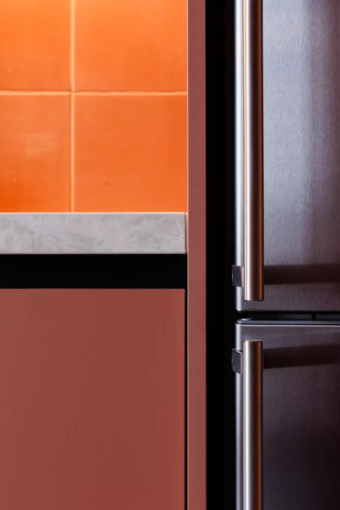 Custom red kitchen designed by Vitelier at Edificio Amalia in Colonia Nápoles, Mexico City.