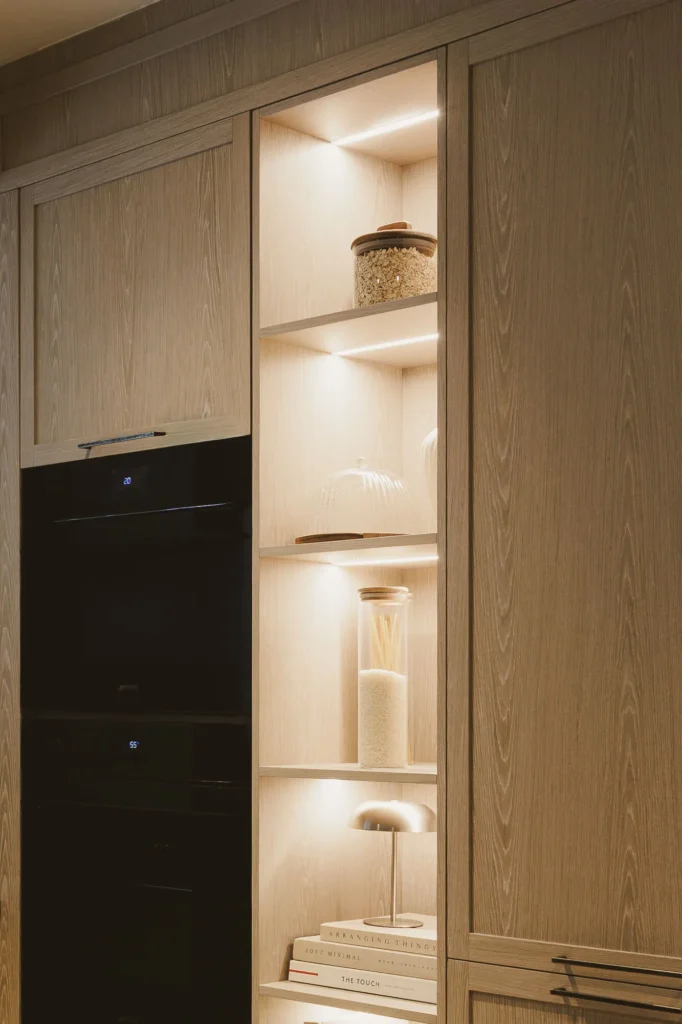 Open module in a patina wood kitchen with sintered stone countertop