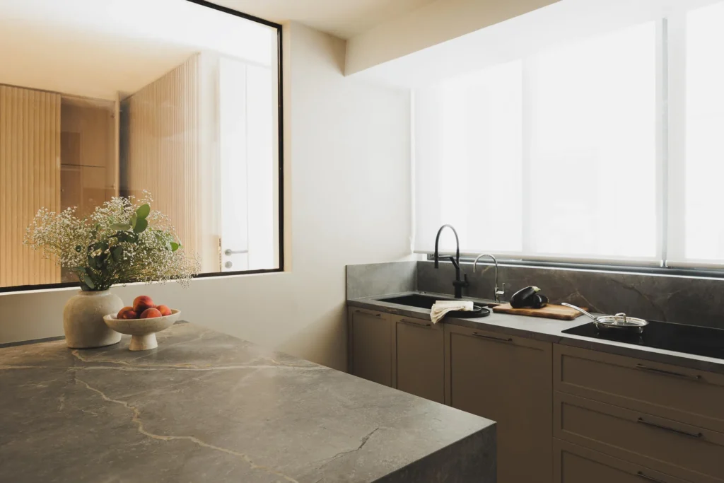 Sintered stone countertop in a custom kitchen designed by Vitelier, showing the surface integrated with wood cabinetry