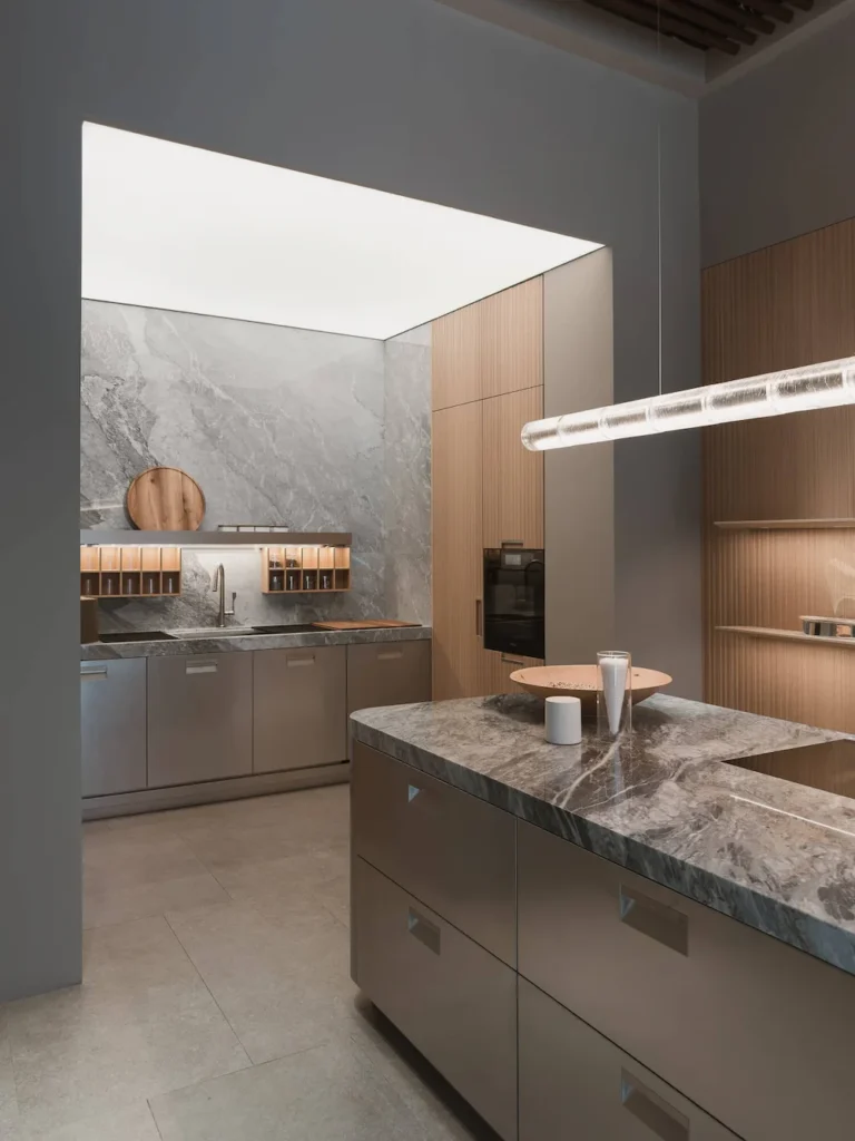 Arclinea showroom at EuroCucina 2026 with Kora island marble countertop wood paneling and functional backsplash